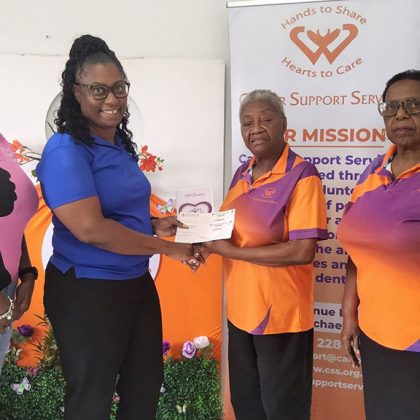 4 people assembled for a presentation of a donation