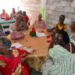 Colorfully dressed ladies sitting at a round table